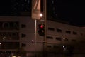 Red traffic light at night, for pedestrians on the street - warning sign not to cross the road Royalty Free Stock Photo