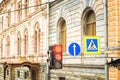 Red traffic light and pedestrian crossing road sign. Beautiful old architecture Royalty Free Stock Photo