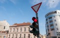 Red traffic light for vehicles and cars on the crosswalk on the street in the city close up with buildings and blue sky background Royalty Free Stock Photo