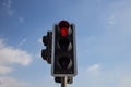 Red traffic light . Blue sky with few clouds background. Close up under view. Royalty Free Stock Photo