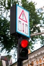 Red traffic light with warning sign. Royalty Free Stock Photo