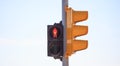 Red traffic light stops pedestrian for the crossing of the road. Sky backdrop, space, banner, detail Royalty Free Stock Photo