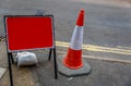 Red traffic sign next to a cone Royalty Free Stock Photo