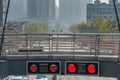 Red traffic signal lights on pedestrian overpass under air pollution fog Royalty Free Stock Photo