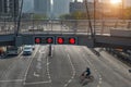 Red traffic signal lights on pedestrian overpass over street road Royalty Free Stock Photo