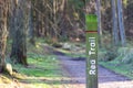 Red trail signpost next to path in Tyrebagger forest Royalty Free Stock Photo