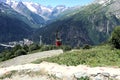 Red trailer on a cable car among the mountains on a summer day Royalty Free Stock Photo