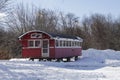 red train car converted to stationary diner in the midst of fresh snow