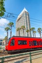 Red Train in front of city building, San Diego