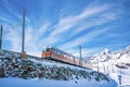 Famous red train running towards gornergrat station on mountain against sky Royalty Free Stock Photo