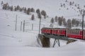 Red train in the snow in swiss alps Royalty Free Stock Photo