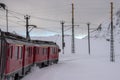 Red train in the snow in swiss alps Royalty Free Stock Photo