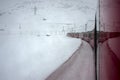 Red train in the snow in swiss alps Royalty Free Stock Photo