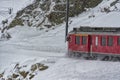 Red train in the snow in swiss alps Royalty Free Stock Photo