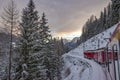 Red train in the snow in swiss alps Royalty Free Stock Photo