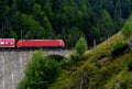 Red train on stone trestle Royalty Free Stock Photo