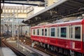 Red train stopping at Kyoto station, Japan