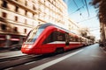 A red train traveling down tracks next to tall buildings Royalty Free Stock Photo