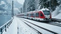 Red train travels in a valley covered by heavy snow in background on a sunny winter day Royalty Free Stock Photo