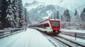 Red train travels in a valley covered by heavy snow in background on a sunny winter day Royalty Free Stock Photo