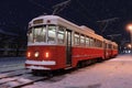 Red tram in the city during a snowfall at night, Trolleybus in winter