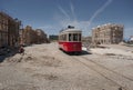 Red tram and cobble streets under construction