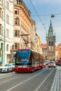 Red tram near Jindrisska Tower in Prague, Czech