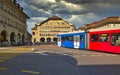 Red tram on the street in the city center of the Swiss capital.