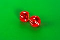 Red transparent dice for gambling on green background Royalty Free Stock Photo