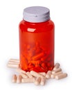 Red transparent plastic bottle with scattered capsules Royalty Free Stock Photo