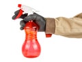 Red transparent plastic spray bottle in worker hand in black protective glove and brown uniform isolated on white background Royalty Free Stock Photo