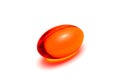 Red transparent supplement capsule on white background