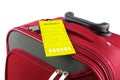 Red travel case and yellow information label Royalty Free Stock Photo