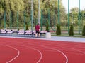 Red treadmill on the football field. Open stadium for sports competitions. Active and healthy lifestyle. Forward movement. Olympic