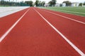 Red treadmill on sport field. Running track on the stadium with rubber coating Royalty Free Stock Photo