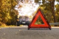 Red triangle, red emergency stop sign, red emergency symbol and black car stop and park on road Royalty Free Stock Photo