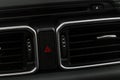 Red triangle hazard light button on car dashboard. Royalty Free Stock Photo