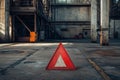 A red triangle with a white line in the middle is on a grey concrete floor Royalty Free Stock Photo