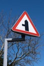 Red triangular sign warning of road on left Saughall Massie Wirral May 2021 Royalty Free Stock Photo