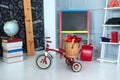 Red tricycle with basket apples. Back to school. Elementary school. Chalkboard, Books, globe in classroom. Teachers Day. Royalty Free Stock Photo