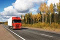 Red truck on autumn highway Royalty Free Stock Photo