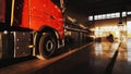 Red truck with cargo trailer pulls into a service station for annual service. Royalty Free Stock Photo