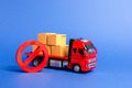 A red truck loaded with boxes and a red symbol NO. Embargo trade wars. Restriction on importation, ban on export of dual-use goods Royalty Free Stock Photo