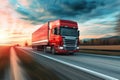 Red truck swiftly moving on road at sunset Royalty Free Stock Photo