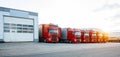 Red trucks in row near storage in sunset Royalty Free Stock Photo