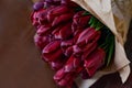 Red tulip bouquet on wooden background Royalty Free Stock Photo