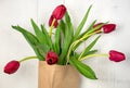 Red tulips in brown bag