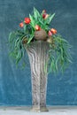 Red tulips in a tall art deco vase.