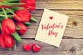 Red tulips and Valentine`s day greeting card Royalty Free Stock Photo