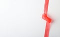 Red tulle ribbon on right with knot on white background Royalty Free Stock Photo
